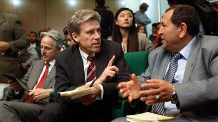 U.S. envoy Chris Stevens, center, accompanied by British envoy Christopher Prentice, left, speaks to Council member for Misrata Dr. Suleiman Fortia, right,