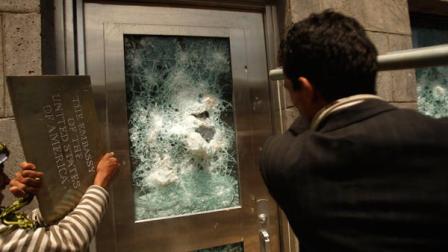 Yemeni protestors break a door of the U.S. Embassy during a protest about a film ridiculing Islams Prophet Muhammad, in Sanaa, Yemen