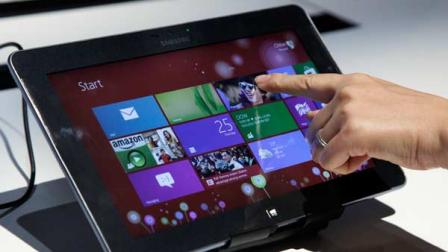 A person tries a Samsung tablet computer running Windows 8 at the launch of Microsoft Windows 8, in New York, Thursday, Oct. 25, 2012. Windows 8 is the most dramatic overhaul of the personal computer markets dominant operating system in 17 years.