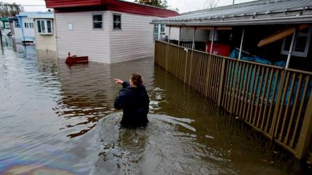 Andrea Grolon walks through waist-deep water in the Metropolitan Trailer Park in Moonachie, N.J. on Tuesday, Oct. 30, 2012.