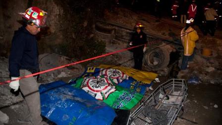 Firefighters stand by the covered bodies of four people who died in the earthquake in San Marcos, Guatemala, Wednesday, Nov. 7, 2012. The mountain village suffered much of the damage after a 7.4-magnitude earthquake struck off the Pacific coast on Wednesday. More than 30 people died and about 100 people are missing. (AP Photo/Moises Castillo)