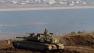 Israeli soldier on top a tank in position overlooking the Syrian village of Bariqa