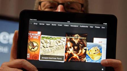 Amazon Kindle vice president Peter Larsen holds the Kindle Fire HD at the introduction of the new Kindle devices in Santa Monica, Calif., Thursday, Sept. 6, 2012.