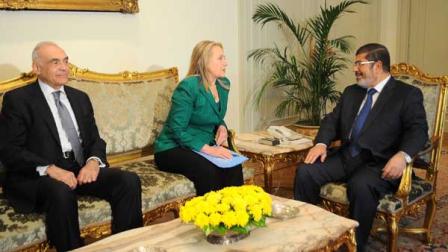 U.S. Secretary of State Hillary Rodham Clinton, center, meets with Egyptian President Mohammed Morsi, right, and Egyptian Foreign Minister Mohammed Kamel Amr