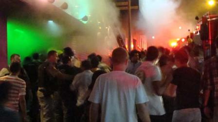 A crowd stands outside the Kiss nightclub during a fire inside the club in Santa Maria city, Rio Grande do Sul state, Brazil