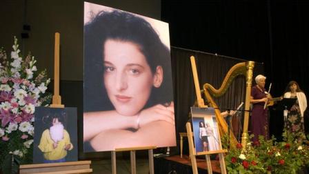 FILE - In this May 28, 2002 file photo taken at the Modesto Centre Plaza in Modesto, Calif. photos of Chandra Levy are on display as musicians, right, stand by at the memorial service for Levy.