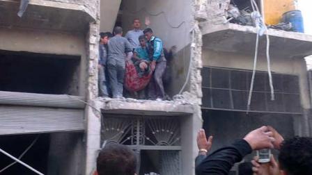 Syrian citizens carry an injured man from a damaged building
