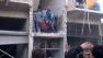 Syrian citizens carry an injured man from a damaged building
