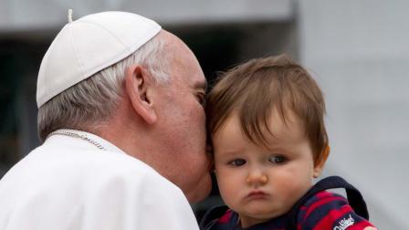 Pope Francis kisses Johnny Oliver Sweeney, from Virginia, United States, as he leaves his weekly general audience in St. Peter square at the Vatican Wednesday, April 3, 2013.
