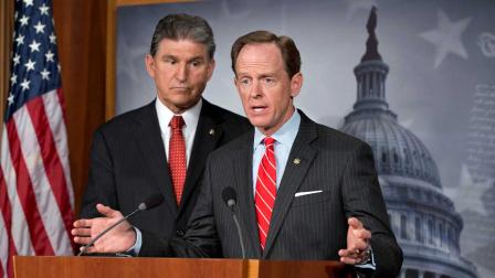 Democratic Sen. Joe Manchin of West Virginia, left, and Republican Sen. Patrick Toomey of Pennsylvania, right, announce that they have reached a bipartisan deal on expanding background checks to more gun buyers