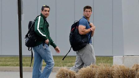 New York Jets quarterback Tim Tebow, right, walks with former NFL punter, now Jets assistant special teams coach, Louis Aguiar, as they arrive at the New York Jets practice facility in Florham Park, N.J., Monday, April 15, 2013.