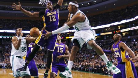 Boston Celtics forward Paul Pierce (34) dumps off the ball to center Jason Collins (98) as he is pressured by Los Angeles Lakers center Dwight Howard (12) during the first quarter of an NBA basketball game in Boston