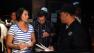 Yanira Maldonado, 42, left, accompanied by her husband, Gary, center, speaks to an official after being released from a prison