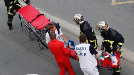 Rescue workers transport a victim from a train that derailed in Bretigny sur Orge, south of Paris, Friday July, 12, 2013.
