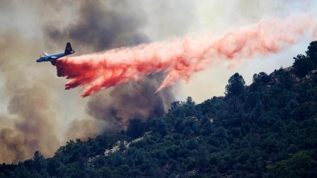 A bomber drops retardant on a wildfire in Mount Diablo State Park on Monday, Sept. 9, 2013 in Contra Costa County, Calif. A wildfire burning outside Mount Diablo State Park has forced dozens of residents and animals to evacuate Monday.