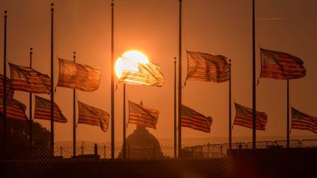 The American flags surrounding the Washington Monument fly at half-staff as ordered by President Barack Obama following the deadly shooting Monday at the Washington Navy Yard, Tuesday morning, Sept. 17, 2013, in Washington.