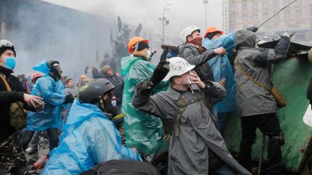 Anti-government protesters throw stones during clashes with riot police in Kievs Independence Square, the epicenter of the countrys current unrest, Kiev, Ukraine, Wednesday