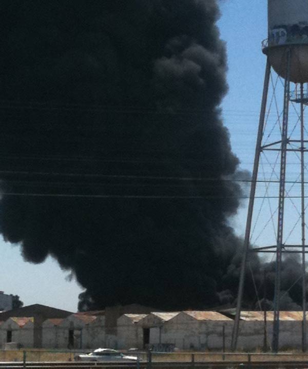 The black plumes of smoke is visible from much...