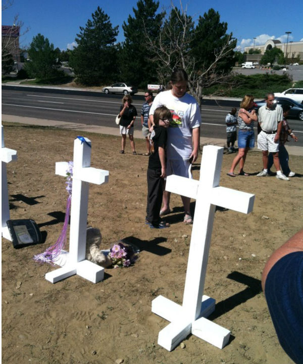 A woman and her son visit the memorial site.