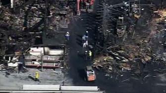 Investigation continues into massive lumber yard fire