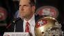 Jim Harbaugh listens to a question during a news conference, Friday, Jan. 7, 2011, in San Francisco.