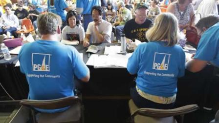 PG&E workers help evacuees file paper work at an evacuation center in San Bruno, Calif., Saturday, Sept. 11, 2010.
