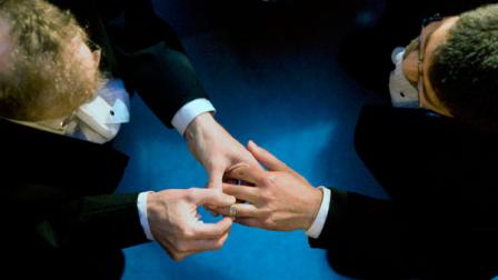 **FILE** In this file photo from June 17, 2008, John Lewis, left, puts a wedding ring on the hand of Stuart Gaffney as they exchange marriage vows at City Hall in San Francisco.