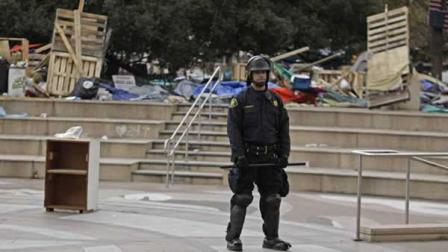 An Alameda County Sheriff stands guard over Frank Ogawa Plaza where an Occupy Oakland encampment was evicted Monday, Nov. 14, 2011, in Oakland, Calif.