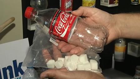 A bottle of soda and sugar cubes