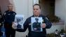 The Santa Cruz police chief holds up photos of slain officers Loran Butch Baker and Elizabeth Butler.