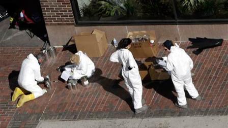 Investigators inspect the area between the two blast sites near the Boston Marathon finish line, Thursday, April 18, 2013, in Boston.