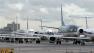 Airplanes backed up on tarmac