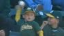 A young As fan threw back a foul ball, without realizing what he was doing.