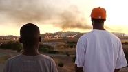 two people watching the fire at the Chevron Richmond Refinery on Aug. 6, 2012