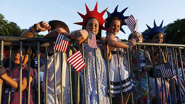 Young spectators wait for the start of the Boston Pops Fourth of July concert rehearsal at the Hatch Shell in Boston, Wednesday, July 3, 2013