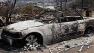 The charred remains of a car are shown after a wildfire passed through the area, Thursday July 18, 2013 in Lake Hemet, California