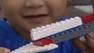 A young boy plays with a Lego set.