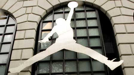 A pedestrian runs past the famous Nike Air Jordan logo in front of the Niketown store in downtown Portland, Ore. on Tuesday, Sept. 29, 2009. (AP Photo/Don Ryan)