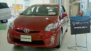 A Prius sits in a Toyota showroom.