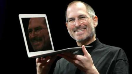 FILE - Apple CEO Steve Jobs holds up the new MacBook Air while giving the keynote address at Apple MacWorld Conference in San Francisco, Tuesday, Jan. 15, 2008. The super-slim new laptop is less than an inch thick and turns on the moment its opened.
