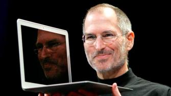 FILE - In this Jan. 15, 2008, file photo, Apple CEO Steve Jobs holds up the new MacBook Air after giving the keynote address at the Apple MacWorld Conference in San Francisco.
