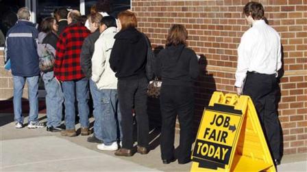 This Jan. 12, 2012 photo shows people waiting in line at a job fair employer hiring event for Safeway in Portland, Oregon.