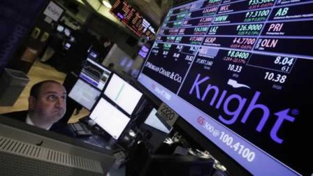Specialist Peter Giacchi looks at the price of Knight at his post on the floor of the New York Stock Exchange, Wednesday, Aug. 1, 2012.