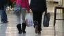 Shoppers carry bags at Bayfair Center in San Leandro