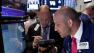 In this Thursday, June 20, 2013, photo, specialist John Parisi, right, works with traders on the floor of the New York Stock Exchange.