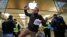 A customer of the Apple store in Oberhausen celebrates with the new iPhone 5S as he leaves the store at the start of the new iPhone sale in Oberhausen, Germany, Friday, Sept. 20, 2013. (AP Photo/Frank Augstein)