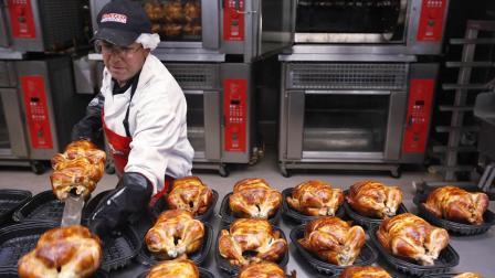 A Costco employee cooks chicken at Costco in Mountain View, Calif., Wednesday, March 3, 2010.