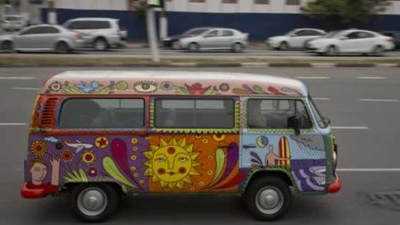 In this Sept. 18, 2013 photo, advertising executive Marcelo Serpa drives his Volkswagen van, or Kombi, emblazoned with a rolling mural, that he painted, through the streets of Sao Paulo, Brazil. Serpas 2007 VW van version is meant to have a 1960s American hippie feel. He painted it in bright green, yellow, blue and red colors with cartoon-like drawings of his wife, daughters, and himself, surfboard in hand. Serpa said the bus evokes a spirit of playfulness and happiness, causing people to pause and smile when he drives it down Sao Paulos chaotic streets.(AP Photo/Andre Penner)