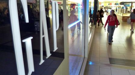 In this May 14, 2012 file photo, shoppers walk by the GAP store at a shopping mall in Peabody, Mass.