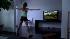 A woman exercises while playing the Nintendo Wii.